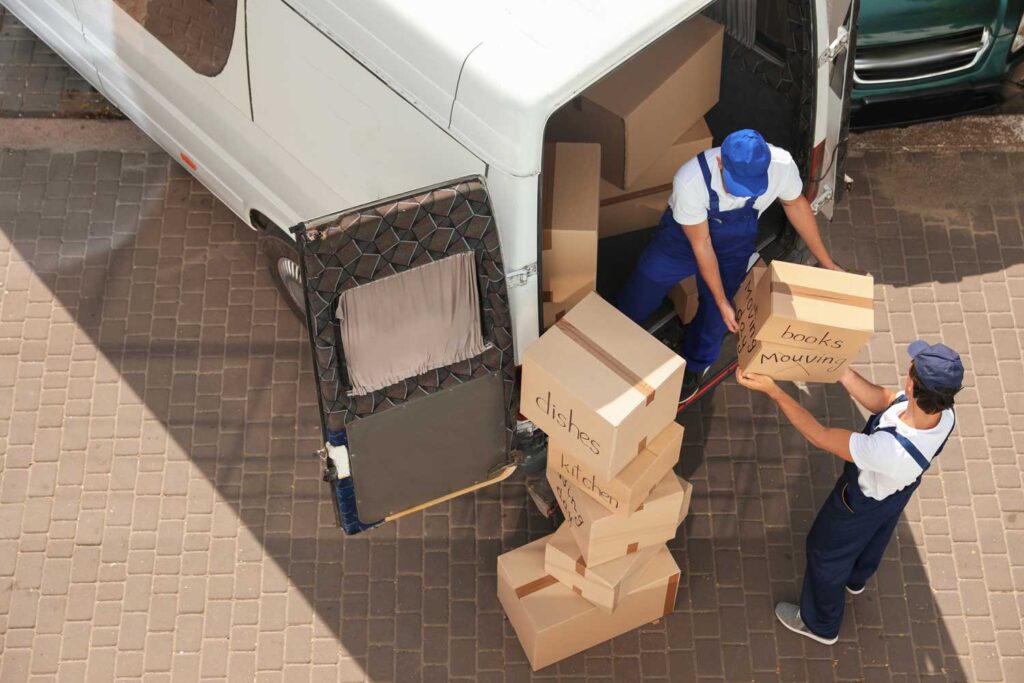 male-movers-unloading-boxes-van-outdoors